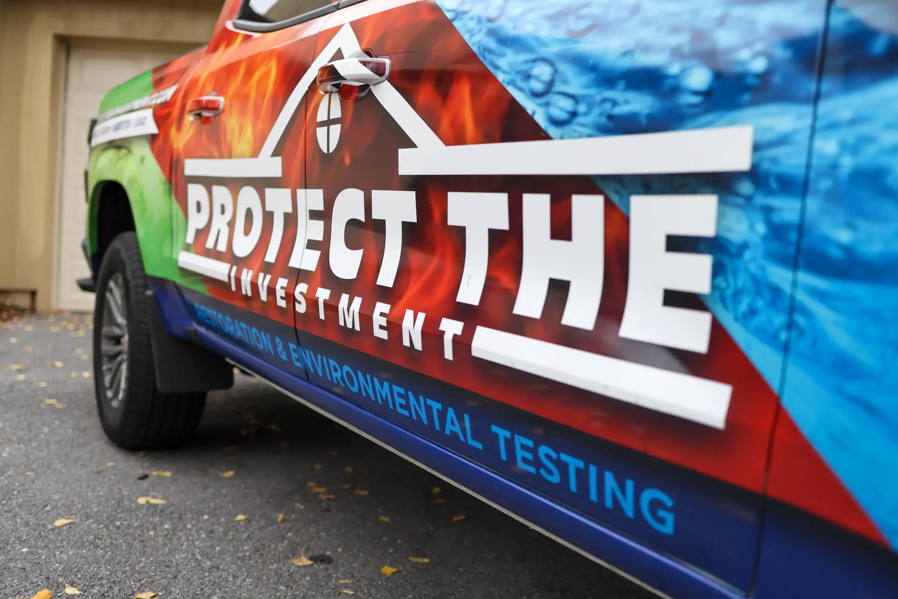 Service vehicle wrap with fire and water graphics displaying home inspection branding