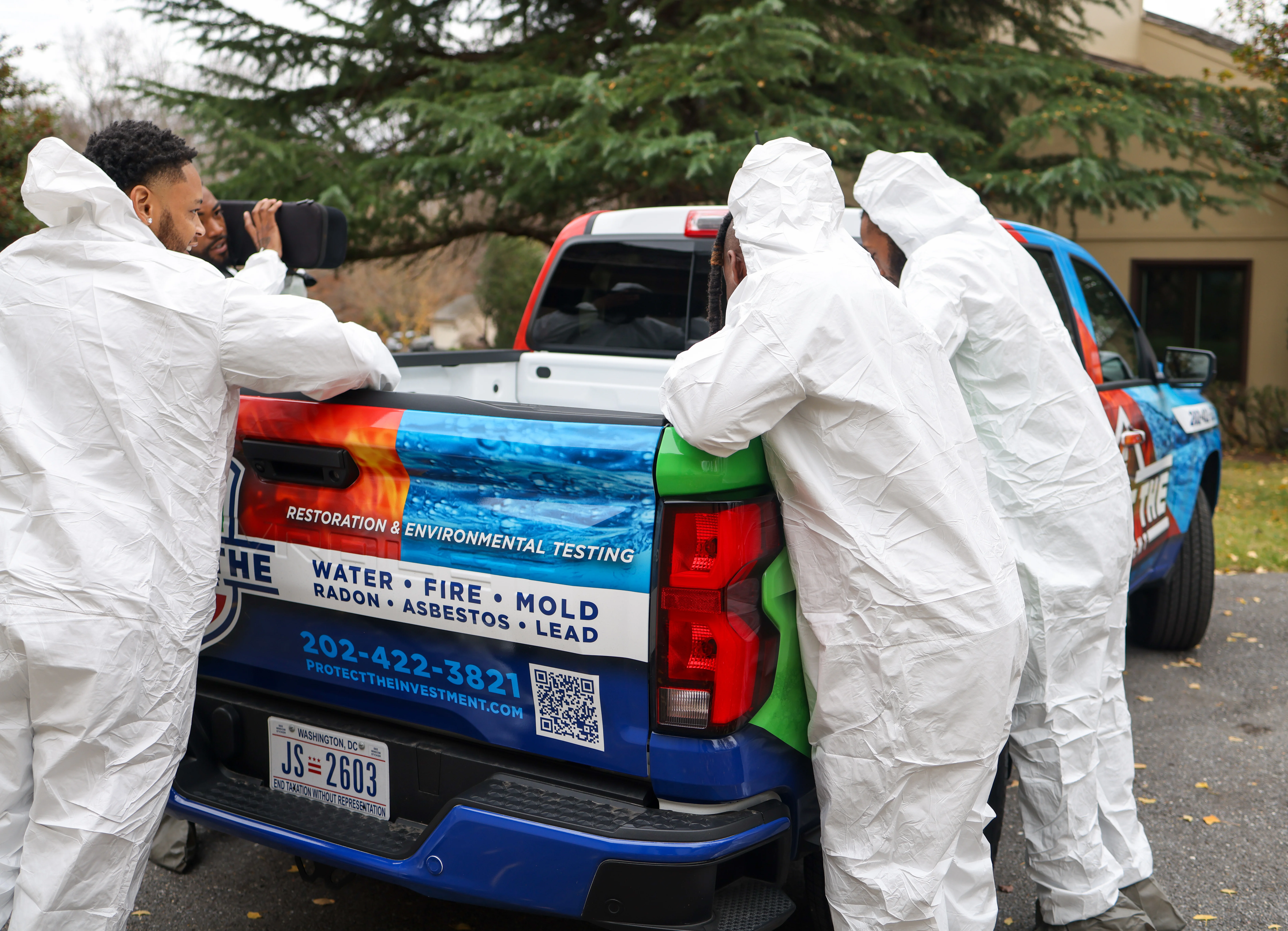 Environmental testing professionals in white protective suits inspecting residential property in Washington, DC