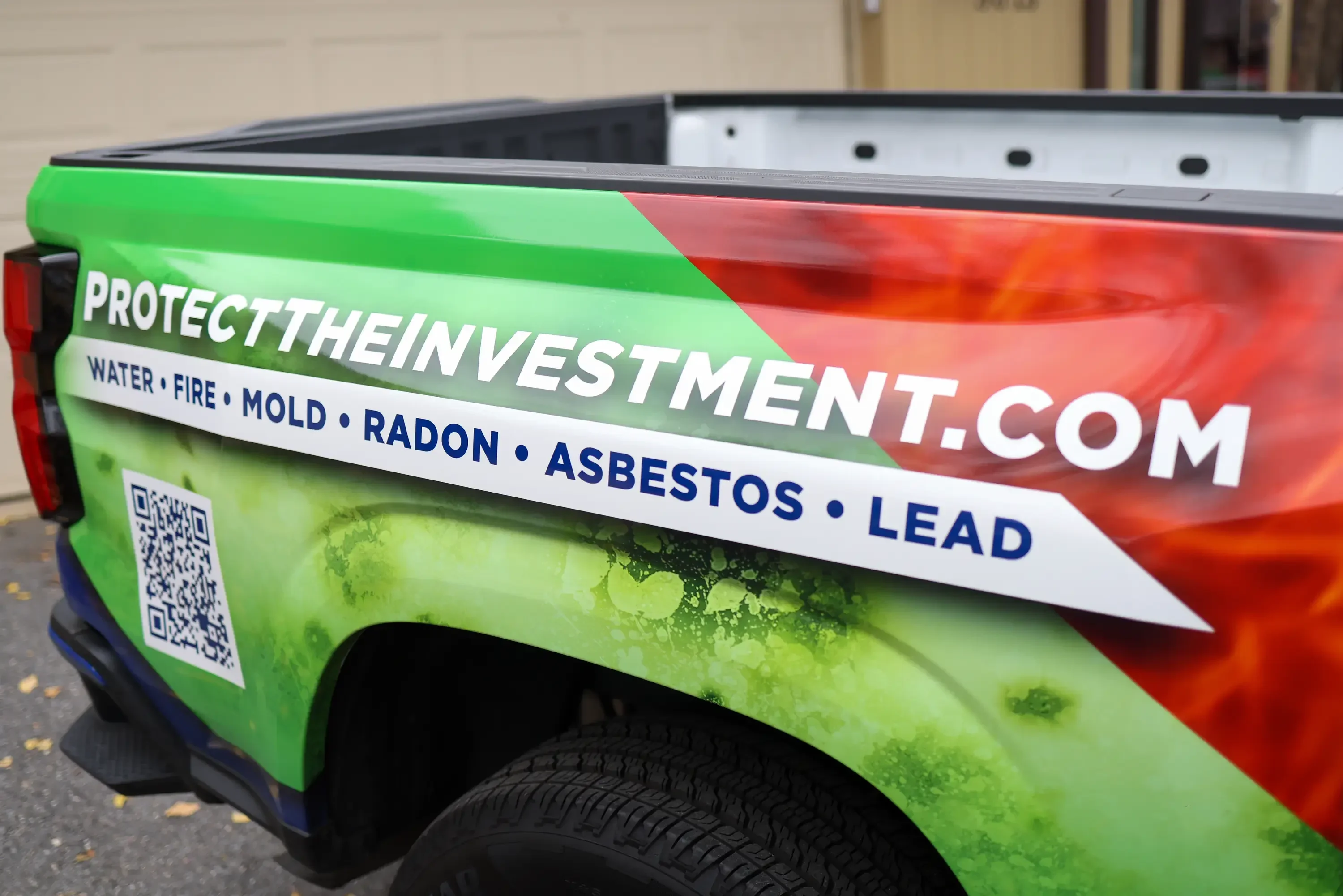 Bright green and red truck wrap with white service text and QR code